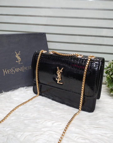 black, crocodile-embossed leather crossbody bag featuring the iconic YSL (Yves Saint Laurent) logo in gold-tone hardware.